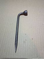 Full view of lug wrench on flat surface