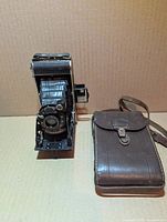 Camera extended next to leather case