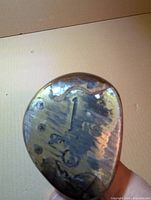 Close-up of brass soleplate stamped 1 on wood driver head