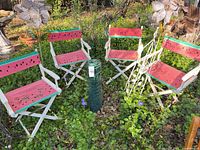 Group shot of all items: four chairs, plant stand, two pinwheels, fence roll