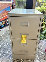 Front view showing three drawers with handles and label holders