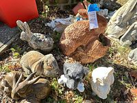 Group of garden animal statues including dogs and rabbits