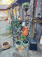 Full view of metal shelf with all garden décor items in place
