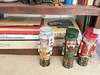 Shelf showing three nutcracker tins and stacked art books including French Impressionism and Picasso