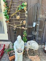Overall lot showing plant stand, trellis, statues and planter