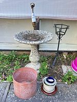 Full lot view showing bird bath, metal stand, terracotta planter, nested small pots