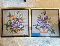 Front view showing both framed embroidered artworks