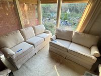 Both sofa and loveseat positioned together in sunroom