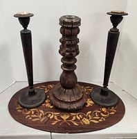 Front view showing three candlestick holders on marquetry plaque