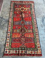 Full view of Turkish rug showing design and wear