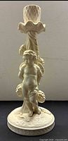 Front view of porcelain cherub candlestick