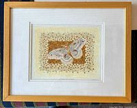 Framed view showing artwork, matting and wood frame