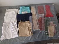 All garments and gloves laid out on surface