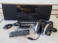 Front view of Pioneer micro stereo system, power adapter, remote control, Lloyd headphones