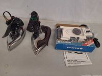 All three travel irons, boxed Sanyo unit plus two chrome irons