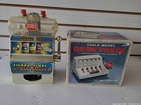 Sunco gumball slot machine beside boxed Waco Draw Poker