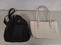 Overview of both bags: black Tommy Hilfiger backpack and white Lauren Ralph Lauren tote