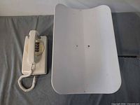 Top view of white beam scale and corded telephone