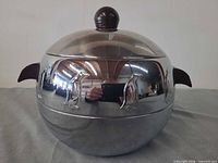 Front view of ice bucket showing penguin embossing, lid and handles