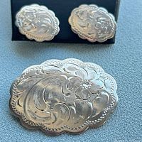 Brooch and earrings together showing matching engraved design