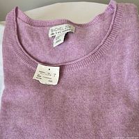 Folded sweater showing overall color and neckline