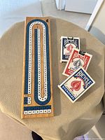 Full view of cribbage board with three Bicycle card decks