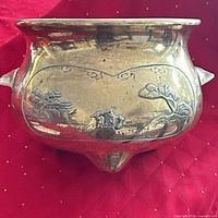 Front view showing overall form, relief scene, handles and legs