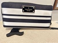 Front view showing black and white stripes and logo plate