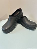 Pair of black Hunter slip-on rain mules displayed side by side