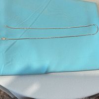 Full view of 18" sterling silver round snake chain laid flat