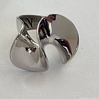 Front view of sculptural sterling ring showing swirl form