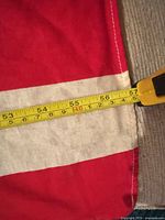 Close-up with tape measure across stripes confirming approx 60-inch length