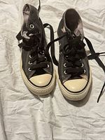 Top view of both sneakers showing laces, toe caps and wear on canvas