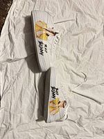 Full pair of sneakers showing custom artwork and overall condition