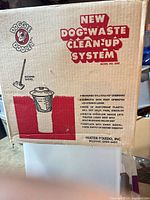Box displaying Doggie Dooley Model 2000 new dog-waste clean-up system branding and specifications