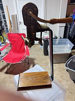 Full view of Estate tabletop lever wine opener showing wood base, black clamp frame, brass components and handle