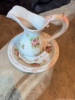 pitcher resting in matching basin showing overall style and decoration