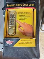 Front view of Lockey model 2210 brass keyless entry door lock in original box