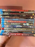 Stack of ten movie cases showing titles