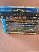 Stacked side view of ten Blu-ray cases displaying titles and spines