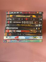 Stack of 10 DVD cases showing spines with titles