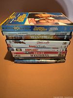 Stack of 9 visible DVD cases plus slipcover showing titles