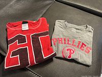 Both folded shirts side by side on sofa