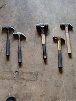 Five hammers laid out showing full form and relative sizes