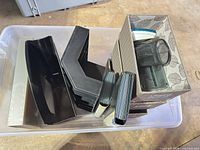 Overall view of assorted desk organizers inside bin