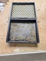 Open case showing foam in lid and residue in base