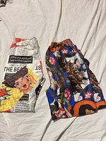 Both pairs folded side by side on bed