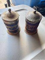 Front view of both labeled canisters with lids in place