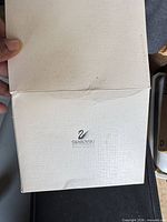 Outer cream Swarovski cardboard box showing logo