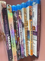 Spine view of seven Tyler Perry Blu-ray movie cases positioned upright